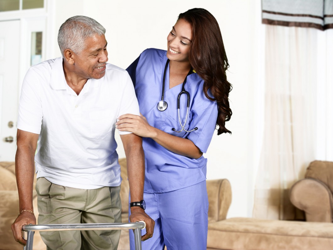 Carer assisting a senior resident with daily living activities
